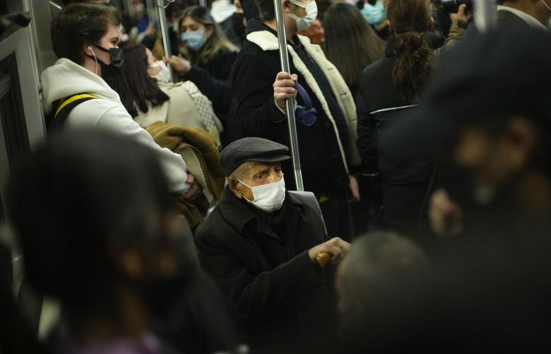 People, all wearing masks to prevent the spread of the COVID-19, take a ride in a metro in Istanbul, Turkey, Thursday, Dec. 2, 2021. The coronavirus’s omicron variant kept a jittery world off-kilter Wednesday, as reports of infections linked to the mutant strain cropped up in more parts of the globe, and one official said that the wait for more information on its dangers felt like “an eternity”. (AP Photo/Francisco Seco) FS101 FS101