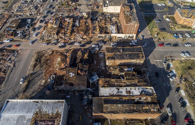 In this photo taken by a drone, buildings are demolished in downtown Mayfield, Ky., on Saturday, Dec. 11, 2021, after a tornado traveled through the region Friday night. A monstrous tornado killed dozens of people in Kentucky and the toll was climbing Saturday after severe weather ripped through at least five states, leaving widespread devastation. (Ryan C. Hermens/Lexington Herald-Leader via AP) KYLEL400 KYLEL400