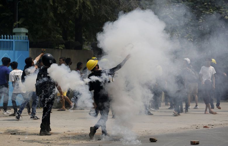Demostrators hurl back tear gas canisters towards police during a protest against the military coup Saturday, March 27, 2021, in Mandalay, Myanmar. Myanmar security forces reportedly killed 93 people Saturday in the deadliest day since last monthâ€™s military coup. (AP Photo) MMRM101 MMRM101