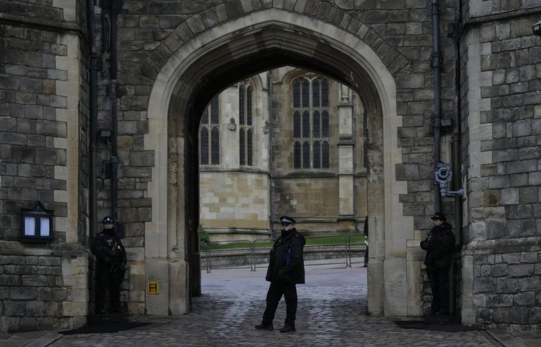 Police guard the Henry VIII gate at Windsor Castle at Windsor, England on Christmas Day, Saturday, Dec. 25, 2021. Britain’s Queen Elizabeth II has stayed at Windsor Castle instead of spending Christmas at her Sandringham estate due to the ongoing COVID-19 pandemic. (AP Photo/Alastair Grant) XAG103 XAG103