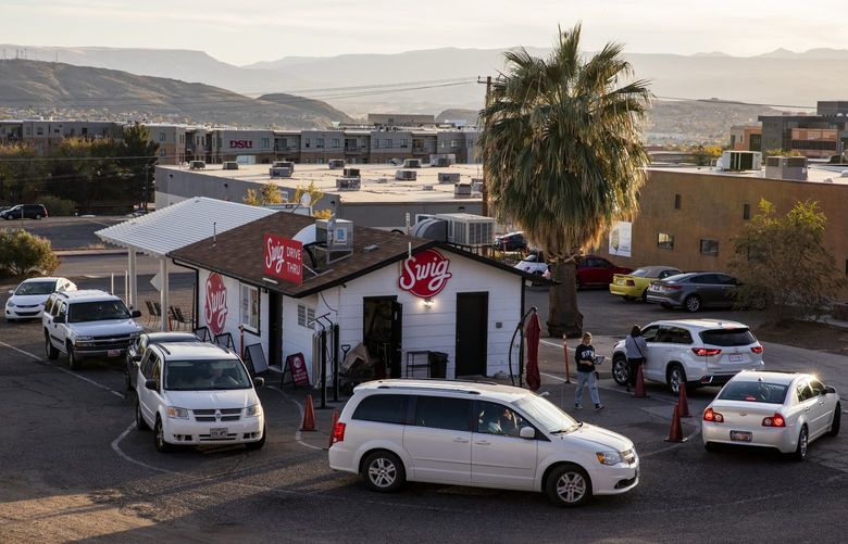Vehicles in the drive-through lane at the original Swig, which now has nearly 40 locations, in St. George, Utah, Nov. 20, 2021. With locations now numbering in the hundreds, regional soda-shop chains are spreading far beyond Utah, where they first found popularity. (Joe Buglewicz/The New York Times) XNYT142 XNYT142