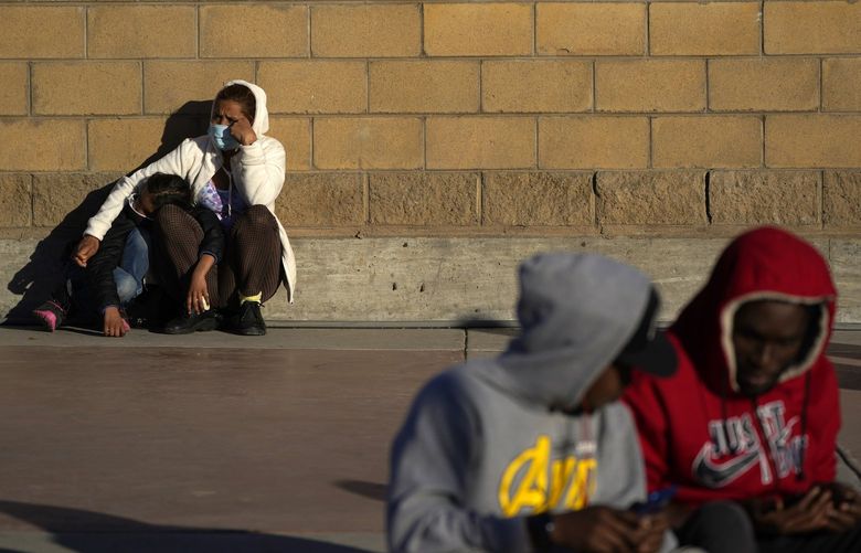FILE – Asylum seekers wait for news of policy changes at the border on Feb. 19, 2021, in Tijuana, Mexico. The Biden administration is set to reinstate a Trump-era policy to make asylum-seekers wait in Mexico for hearings in U.S. immigration court this week with changes and additions. A U.S. official says the first migrants are to be sent from El Paso, Texas, back to Ciudad Juarez. Timing was in flux as officials made final preparations but it may begin Tuesday, Dec. 7, 2021. (AP Photo/Gregory Bull) FX102 FX102