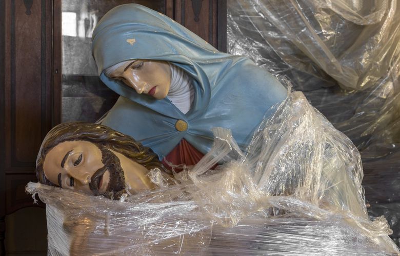 A plaster pieta of Mary cradling Jesus’s dead body at the Patrimony Warehouse of the Archdiocese of New York, Dec. 14, 2021. In a warehouse on Staten Island, the Archdiocese of New York stores altars, statuary and other relics that can be reused in churches around the world. (Tom Sibley/The New York Times)