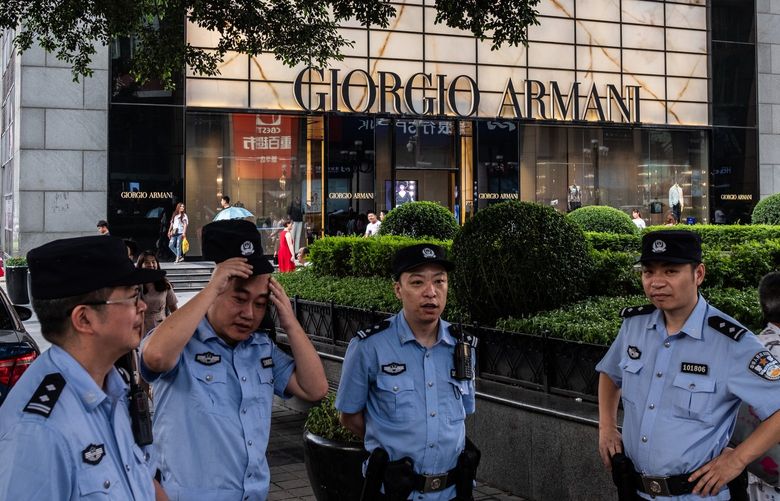 FILE – Police on patrol in a luxury shopping district of Chongqing, China, June 9, 2018. The Chinese authorities have declared war on content deemed to be “flaunting wealth,” amid sweeping calls by China’s leader, Xi Jinping, to combat inequality. (The New York Times)