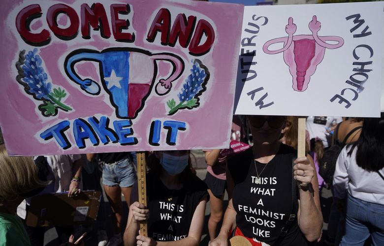 FILE —Demonstrators rally to to demand continued access to abortion during the March for Reproductive Justice, Oct. 2, 2021, in downtown Los Angeles. On Wednesday Dec. 8, 2021, a group of abortion providers and advocacy groups recommended California should use public money to bring people here from other states for abortion services should the U.S. Supreme Court overturn Roe v. Wade. The report has the backing of key legislative leaders, including Senate President Pro Team Toni Atkins, a Democrat. (AP Photo/Damian Dovarganes, file) SC302 SC302