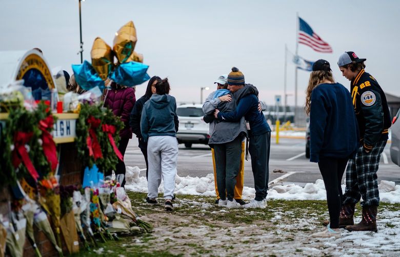 Mourners gather at a makeshift memorial at Oxford High School in Oxford, Mich. on Wednesday, Dec. 1, 2021, following a series of shootings at the school a day earlier. A fourth student died on Wednesday morning following a shooting at Oxford High School in suburban Detroit on Tuesday, the deadliest on school property in the United States this year. (Nick Hagen/The New York Times) XNYT175 XNYT175