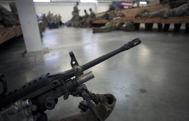 FILE – A U.S. Army soldier’s weapon is shown, Jan. 4, 2020, at Fort Bragg, North Carolina. Two men who forged deep bonds of friendship while serving in the Army in Afghanistan would be arrested in 2018 for a scheme to steal weapons and explosives from an armory at Fort Bragg, North Carolina, and sell them. An Associated Press investigation into lost and stolen military weapons has shown that insider thefts remain a serious concern. (AP Photo/Chris Seward, File) XNC704 XNC704
