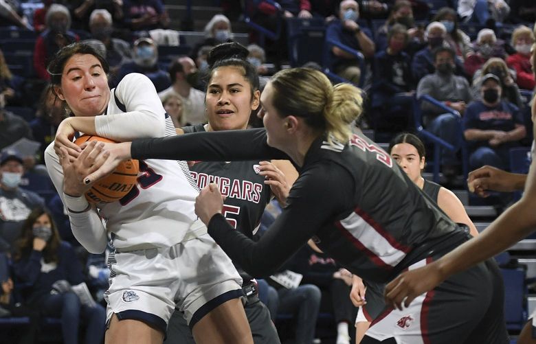 Gonzaga forward Melody Kempton (33) has the ball stripped from her hands by Washington State center Emma Nankervis (3) during an NCAA college basketball game Wednesday, Dec. 8, 2021, in Spokane, Wash. (Colin Mulvany/The Spokesman-Review via AP) WASPO321 WASPO321