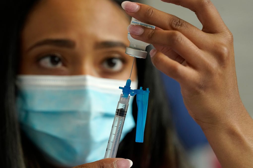 FILE – Licensed practical nurse Yokasta Castro, of Warwick, R.I., draws a Moderna COVID-19 vaccine into a syringe at a mass vaccination clinic, May 19, 2021, at Gillette Stadium, in Foxborough, Mass. While all eyes are on the new and little-understood omicron variant, the delta form of the coronavirus isn’t finished wreaking havoc in the U.S. There is much that is unknown about omicron, including whether it is more contagious than previous versions, makes people sicker or more easily thwarts the vaccine or breaks through the immunity that people get from a bout of COVID-19. (AP Photo/Steven Senne, File)