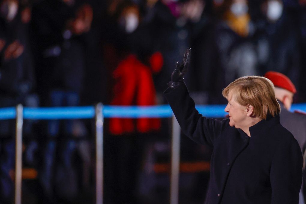 German Chancellor Angela Merkel waves goodbye at the Defence Ministry during the Grand Tattoo (Grosser Zapfenstreich), a ceremonial send-off for her in Berlin on December 2, 2021. (Odd Andersen/Pool Photo via AP)