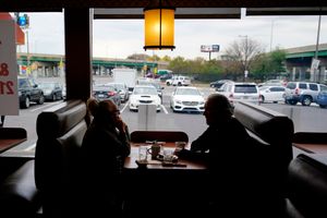 FILE – Customers sit in a booth at the Penrose Diner, Tuesday, Nov. 17, 2020, in south Philadelphia. Philadelphia officials announced Monday, Dec. 13, 2021 that proof of vaccination will be required starting Jan. 3 for bars, restaurants, indoor sporting events, movie theaters and other places where people eat indoors close to each other. (AP Photo/Matt Slocum, File)