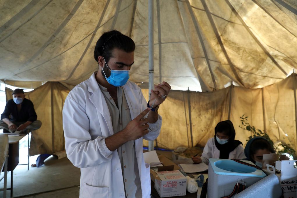 FILE – A doctor fills a syringe with the Johnson & Johnson COVID-19 vaccine donated through the U.N.-backed COVAX program at a vaccination center in Kabul, Afghanistan, Sunday, July 11, 2021. COVAX, created to share coronavirus vaccines fairly, already scaled back its pledge to the world’s poor once. Now, to meet even that limited promise, it would have to deliver more than a million doses every hour until the end of the year. (AP Photo/Rahmat Gul, File)