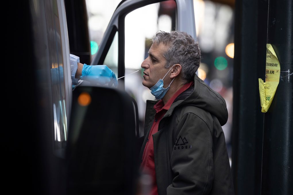 A person takes COVID-19 test at mobile testing site near Grand Central Terminal on Friday, Dec. 3, 2021, in New York. The omicron variant of COVID-19, which had been undetected in the U.S. before the middle of this week, had been discovered in at least five states by the end of Thursday, showing yet again how mutations of the virus can circumnavigate the globe with speed and ease.(AP Photo/Yuki Iwamura)