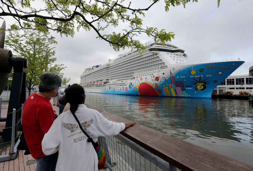 FILE – People pause to look at Norwegian Cruise Line’s ship, Norwegian Breakaway, on the Hudson River, in New York, on May 8, 2013. A cruise ship that carried at least 17 passengers and crew members with COVID-19 breakthrough infections has left New Orleans with new passengers. The Louisiana Department of Health said Monday, Dec. 6, 2021 that nine crew members and eight passengers were infected when the Norwegian Breakaway docked in New Orleans. (AP Photo/Richard Drew, File)