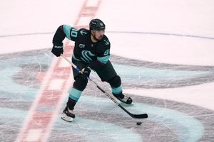 Seattle Kraken left wing Marcus Johansson looks to pass the puck against the Calgary Flames during the first period of an NHL hockey game Thursday, Dec. 30, 2021, in Seattle. (AP Photo/Ted S. Warren)