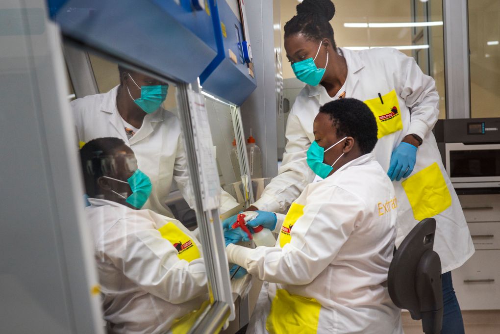 FILE — Melva Mlambo, right, and Puseletso Lesofi, both medical scientists prepare to sequence COVID-19 omicron samples at the Ndlovu Research Center in Elandsdoorn, South Africa, Dec. 8, 2021. Health experts still don’t know if omicron is causing milder COVID-19 but some more hints are emerging with doctors in South Africa saying their patients aren’t getting as sick with omicron, compared to the delta variant. (AP Photo/Jerome Delay, File)