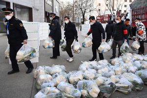 In this photo released by Xinhua News Agency, subdistrict office staff carry daily necessities to be delivered to households under closed-off management in Xi’an, in northwestern China’s Shaanxi Province, Dec. 29, 2021. Chinese officials promised steady deliveries of groceries to residents of Xi’an, an ancient capital with 13 million people that is currently under the strictest lockdown of a major Chinese city since Wuhan was shut early last year at the start of the pandemic. (Liu Xiao/Xinhua via AP)