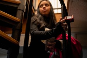 蒂芙尼·帕蒂诺 (Tiffany Patino) 在家中走上楼梯时，戴着脉搏血氧仪监测她的生命体征。 许多长途运输者经常监测他们的生命体征，以确定哪些活动会导致症状恶化。 （华盛顿邮报由卡罗琳·范·霍滕拍摄）。
