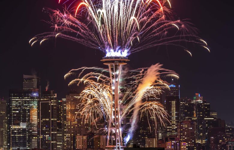 Fireworks adorn the Seattle skyline from the Space Needle as part of the New Year’s Eve celebration seen Saturday from Kerry Park. It’s the first time in three years there have been fireworks at the Space Needle celebrating New Year’s Eve. There were no fireworks on New Year’s Eve 2019 because of high winds or on New Year’s Eve 2020 because of the pandemic.