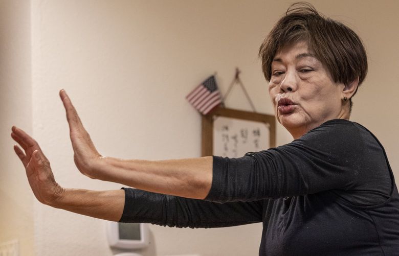 Thursday, December 10, 2021.    Fund For Those In Need.   looking down at the iPad, Yuriko Ueda works out with the ACRS zoom call to exercise with instructor Lily Singh.   Earlier this year ACRS launched the zoom exercise classes for older clients. 219031