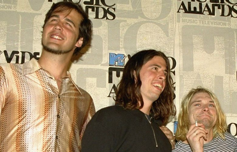 FILE – Nirvana band members, from left, Krist Novoselic, Dave Grohl and Kurt Cobain pose after receiving an award for best alternative video at the 10th annual MTV Video Music Awards in Universal City, Calif., on Sept. 2, 1993. A federal judge has dismissed the lawsuit of a 30-year-old man who alleged that the image of him nude as a baby on the 1991 cover of Nirvanaâ€™s â€œNevermind” is child pornography. Judge Fernando Olguin granted the motion by Nirvana’s attorneys to dismiss the case Monday, Jan. 3, 2022 but said plaintiff Spencer Elden can refile an amended version of the suit. (AP Photo/Mark J. Terrill, File) LA250 LA250
