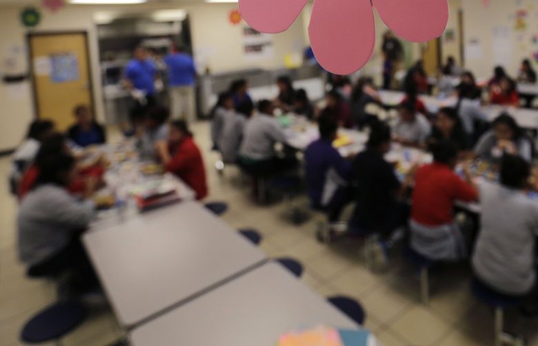 FILE – Migrant teens eat lunch at a “tender-age” facility for babies, children and teens, in Texas’ Rio Grande Valley, on Aug. 29, 2019, in San Benito, Texas. The American Civil Liberties Union says the Department of Justice has withdrawn from talks to settle lawsuits filed on behalf of parents and children who were separated under the Trump administration’s zero-tolerance border enforcement policy. (AP Photo/Eric Gay, File) WX135 WX135