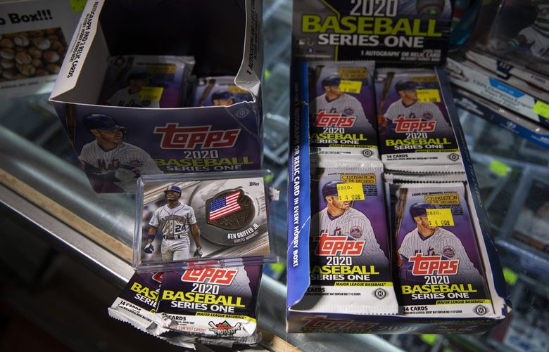 FILE — Topps baseball card packages in New York on Feb. 11, 2020. In a deal sure to reverberate across the collectibles industry, Topps is selling its famed sports card business for an undisclosed price to Fanatics, the sports brand steadily creating a licensing empire. (Benjamin Norman/The New York Times) XNYT31 XNYT31