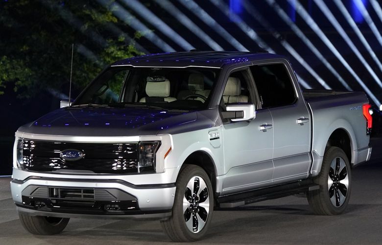 The Ford F-150 Lightning is unveiled, Wednesday, May 19, 2021, in Dearborn, Mich. On the outside, the electric version of Ford’s F-150 pickup looks about the same as the wildly popular gas-powered truck. The new truck called the F-150 Lightning can go up to 300 miles per charge, with a starting price of just under $40,000. (AP Photo/Carlos Osorio)