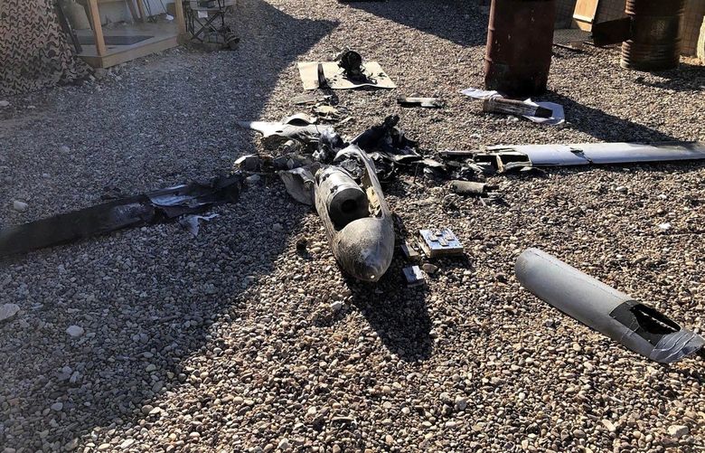 Parts of the wreckage of a drone are laid out on the ground near the Ain al-Asad airbase, in the western Anbar province of Iraq, Tuesday, Jan. 4, 2022. Two explosives-laden drones targeting the base housing U.S. troops were engaged and destroyed by defensive capabilities at the base on Tuesday, a coalition official said. (International Coalition via AP) BAG101 BAG101
