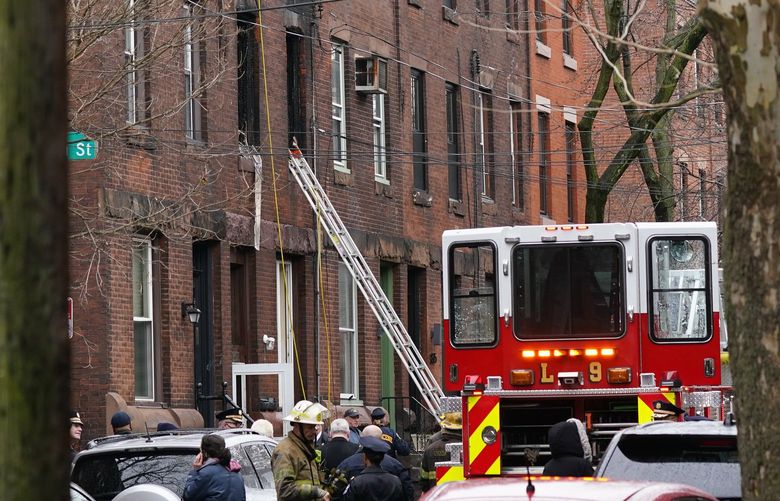 Philadelphia firefighters work at the scene of a deadly row house fire, Wednesday, Jan. 5, 2022, in the Fairmount neighborhood of Philadelphia. (AP Photo/Matt Rourke) PAMS105 PAMS105