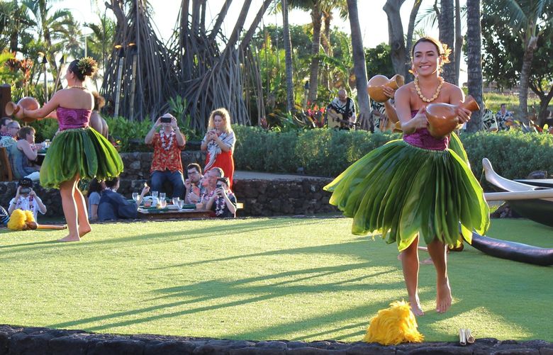 This Feb. 19, 2018 photo shows hula dancers telling their stories through graceful moves at a traditional hula and feast, the Old Lahaina Luau, in Maui. (AP Photo/Jennifer McDermott)