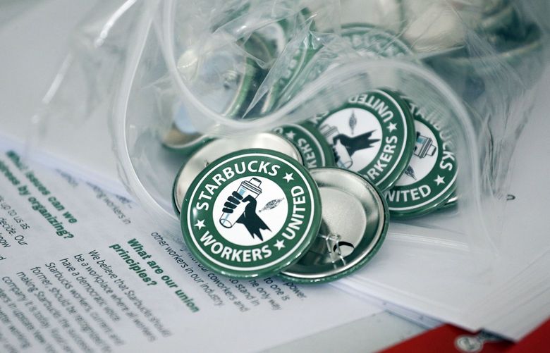 FILE â€” Pro-union pins sit on a table during a watch party for Starbucks’ employees union election, Dec. 9, 2021, in Buffalo, N.Y. Starbucks says it will negotiate in good faith with workers whoâ€™ve agreed to unionize in Buffalo. In a bargain letter sent to all U.S. partners, Executive Vice President Rossann Williams said that the company hasnâ€™t wanted unionization, but respects the legal process and wants to work with those in Buffalo who voted in favor of union representation. (AP Photo/Joshua Bessex, File) NYPS205 NYPS205