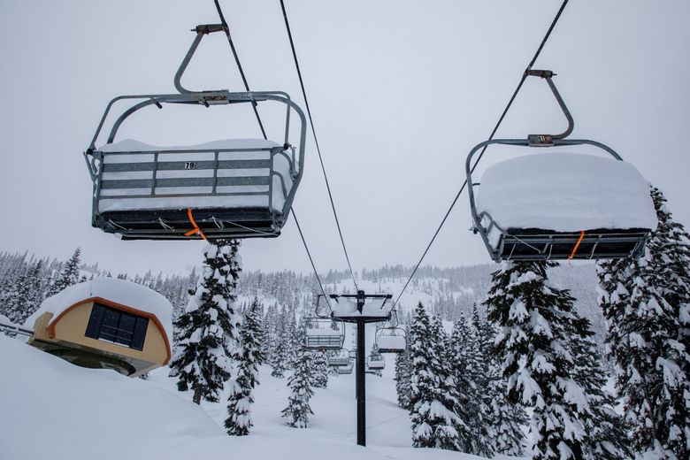 Chairs on the Southern Cross chairlift at Stevens Pass buried under deep snow last week. Southern Cross is one lift that has not opened this year due to staffing shortages.  (Jennifer Buchanan / The Seattle Times)