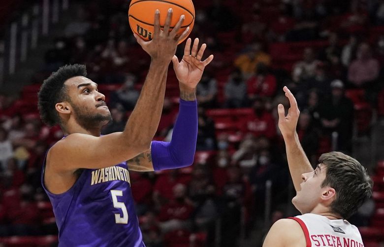 Washington guard Jamal Bey (5) goes to the basket as Utah guard Lazar Stefanovic (20) defends during the first half of an NCAA college basketball game Thursday, Jan. 6, 2022, in Salt Lake City. (AP Photo/Rick Bowmer) UTRB123 UTRB123
