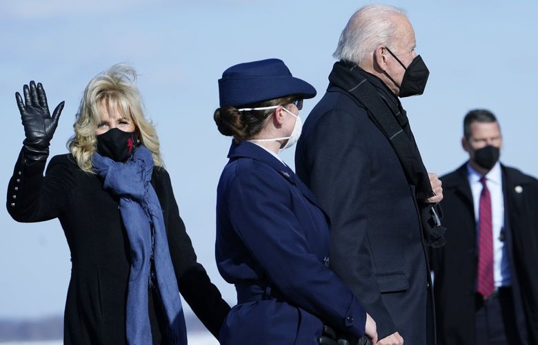 First lady Jill Biden waves and she and President Joe Biden walk toward Air Force One at Andrews Air Force Base, Md., Friday, Jan. 7, 2022. The Bidens are traveling to Boulder, Colo., to meet with families who were impacted by the recent wildfire. They will then travel to Las Vegas to attend Saturday’s funeral for Harry Reid, the former U.S. Senate majority leader. (AP Photo/Susan Walsh) MDSW204 MDSW204