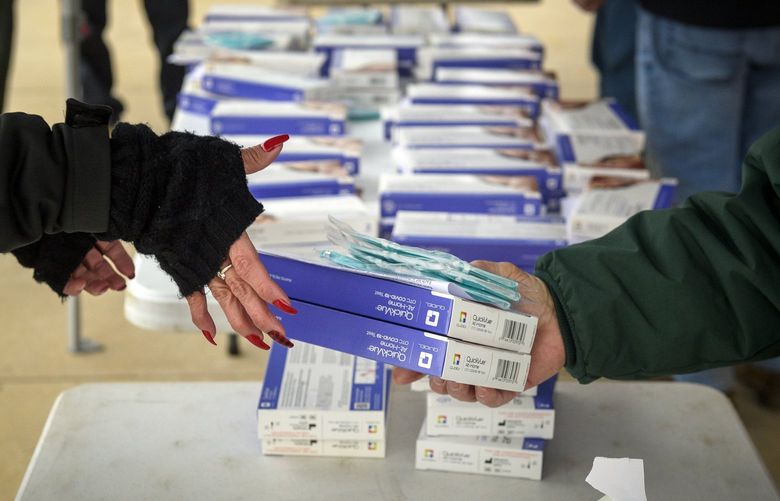 At-home COVID-19 test kits are prepared for distribution Monday morning, Jan. 3, 2022, at a Wethersfield High School drive-through site in Wethersfield, Connecticut. (Mark Mirko/Hartford Courant/TNS) 36822283W 36822283W