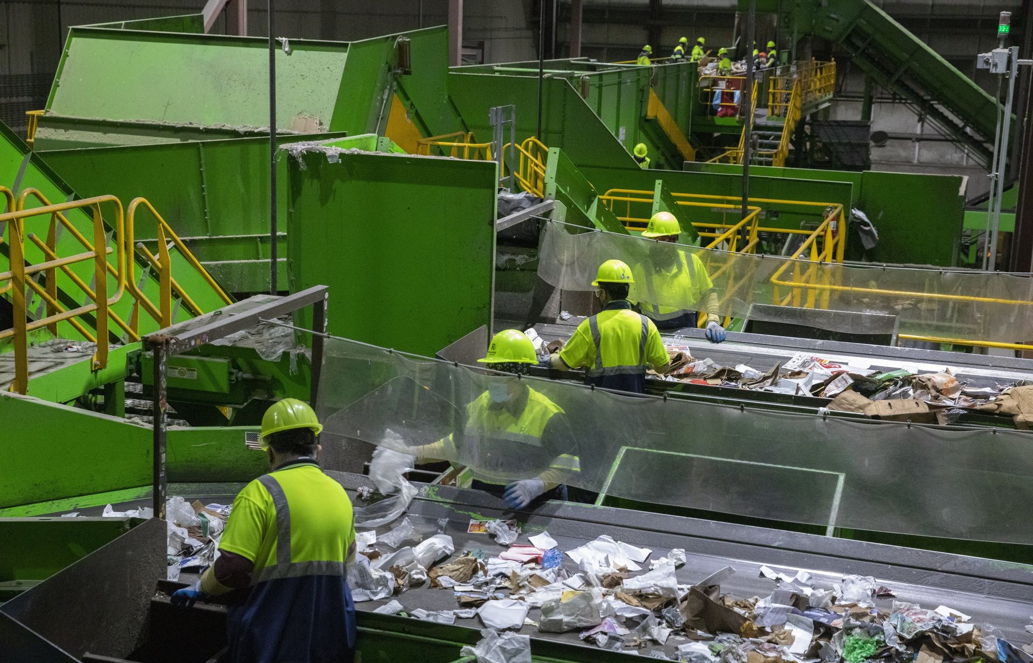 Human sorters remove anything that is not paper or cardboard on a line