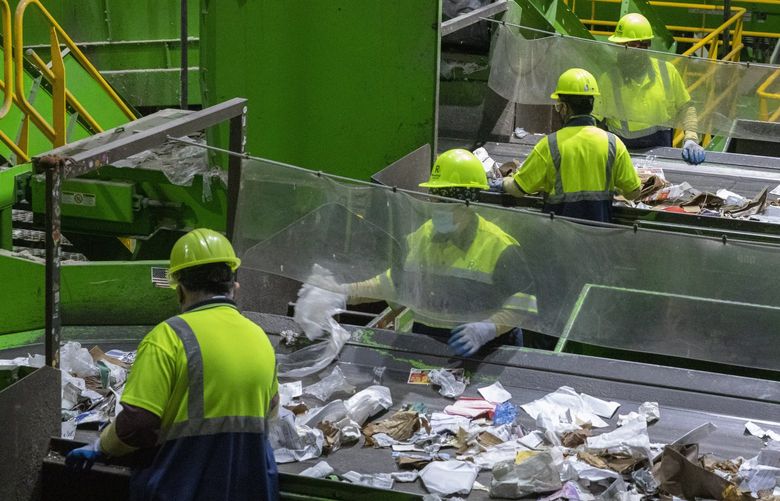 Human sorters remove anything that is not paper or cardboard on a line at King County’s Recology’s Material Recovery Facility in Seattle Monday, November 15, 2021. Ten to 15 percent of the items that people put into their blue recycle bins are not recyclable and have to go to landfills.. People who work on the assembly lines spend a lot of time in quality control and do their best to remove these items.
Monday is ‘America Recycles’ day and King County Solid Waste Division wants to remind everyone as we head into the busy holiday shopping, shipping, packaging, and cooking season that plastic bags, wrap, and other non-recyclable items should not be put in the recycling bin.
Items that belong in the bins are clean and dry hard plastics, paper, glass, cardboard and metals. Plastic bags and wraps should not be placed in recycling bins and can damage or temporarily shut down the equipment. It usually happens at least once a day and several hours every night are removing plastic bags and other items that have wound around the paper screens.
“Wish†recycling (items that people try to recycle but shouldn’t) also cause problems with the machinery at the facility.
People in the northwest are generally good recyclers and because of the low contamination rates in recycled items recyclers buy the recycled baled items. Almost all of of the baled items end up in domestic markets in the Untied States, Canada and Mexico.
218821