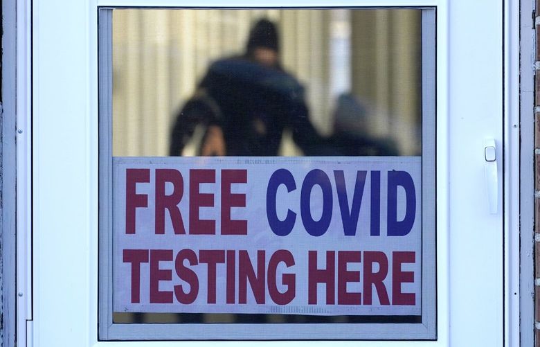 A sign about COVID test is displayed at a testing site as people are seen inside for testing in Morton Grove, Ill., Sunday, Jan. 9, 2022. Hospitalizations of U.S. children under 5 with COVID-19 soared in recent weeks to their highest level since the pandemic began, according to government data released Friday on the only age group not yet eligible for the vaccine. (AP Photo/Nam Y. Huh) ILNH101 ILNH101