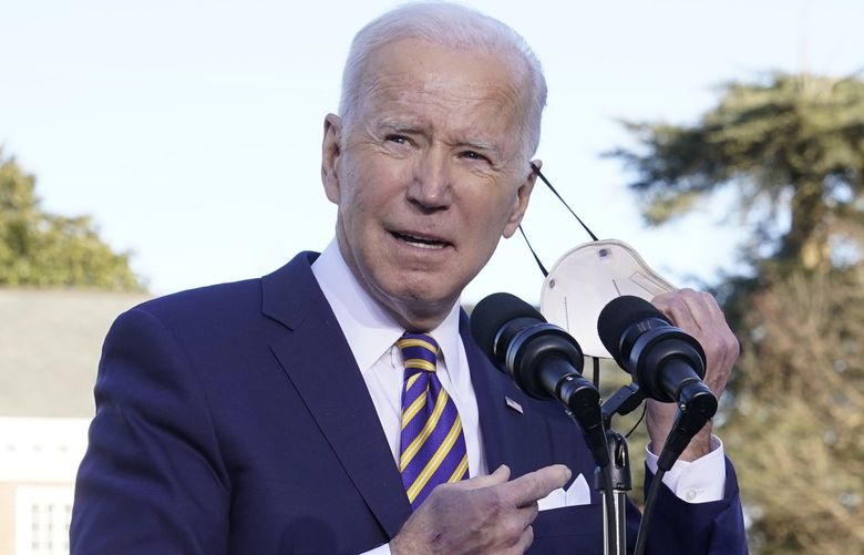 President Joe Biden takes off his face mask as he prepares to speak in support of changing the Senate filibuster rules that have stalled voting rights legislation, at Atlanta University Center Consortium, on the grounds of Morehouse College and Clark Atlanta University, Tuesday, Jan. 11, 2022, in Atlanta. (AP Photo/Patrick Semansky) GAPS327 GAPS327
