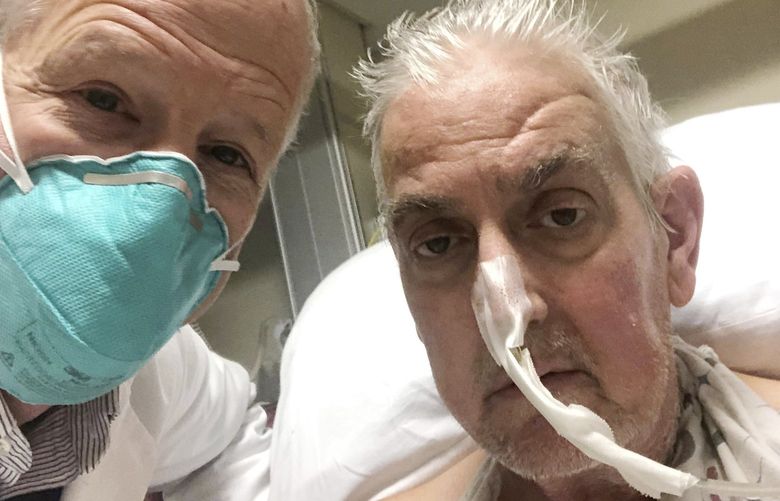In this photo provided by the University of Maryland School of Medicine, Dr. Bartley Griffith takes a selfie photo with patient David Bennett in Baltimore in January 2022. In a medical first, doctors transplanted a pig heart into Bennett in a last-ditch effort to save his life and the hospital said Monday, Jan. 10, 2022 that he’s doing well three days after the highly experimental surgery. (Dr. Bartley Griffith/University of Maryland School of Medicine via AP) NY893 NY893