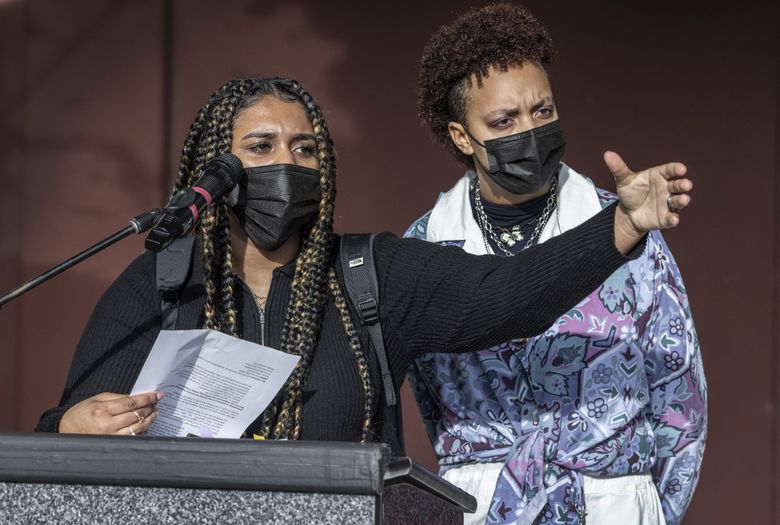 Student organizers Mia Dabney, left, and Nya Spivey speak at Friday’s student sickout and rally, held outside Seattle Public Schools headquarters, demanding stronger health and safety protocols. (Steve Ringman / The Seattle Times)