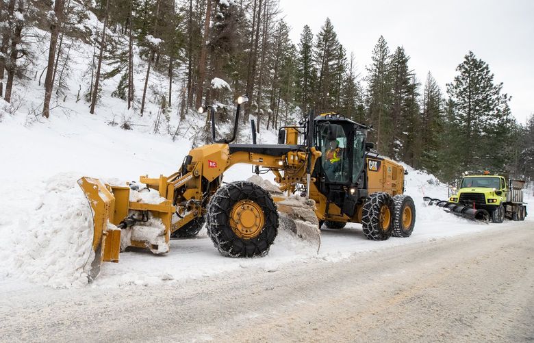 011022
A WSDOT grader with a plow blade attached to the front works to remove snow from lanes of Highway 97 across Blewett Pass as a plow follows closely behind it Monday, Jan. 10, 2022. 219285