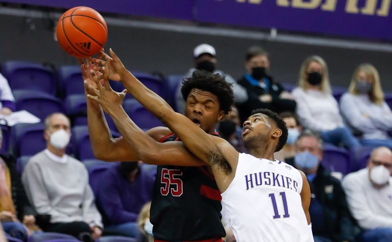 Washington Huskies guard Daejon Davis gets in the way of a pass to Stanford forward Harrison Ingram for a turnover during the first half Saturday, Jan. 15, 2022, in Seattle, Wash.  (Jennifer Buchanan / The Seattle Times)