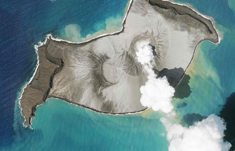 In this satellite photo taken by Planet Labs PBC, an island created by the underwater Hunga Tonga Hunga Ha’apai volcano is seen smoking Jan. 7, 2022. An undersea volcano erupted in spectacular fashion near the Pacific nation of Tonga on Saturday, Jan. 15, sending large tsunami waves crashing across the shore and people rushing to higher ground. A tsunami advisory was in effect for Hawaii, Alaska and the U.S. Pacific coast, with reports of waves pushing boats up in the docks in Hawaii. (Planet Labs PBC via AP) ARE103 ARE103