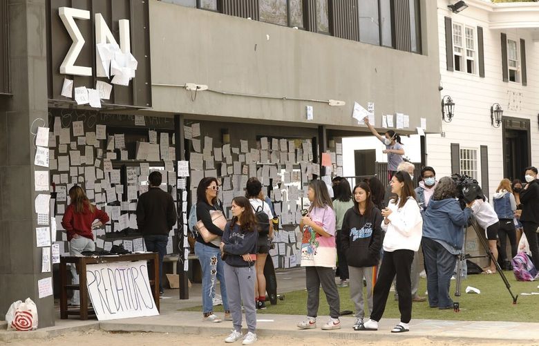 LOS ANGELES, CA – OCTOBER 22: USC students gather Friday afternoon at the Sigma Nu fraternity house near the USC campus. USC officials have placed the Sigma Nu fraternity chapter on interim suspension following allegations that women were drugged and sexually assaulted at the fraternity house. In a crime alert issued Thursday, the USC Department of Public Safety said campus officials received “a report of sexual assault” at the Sigma Nu fraternity house locate at 660 W. 28th St. “The university also has received reports of drugs being placed into drinks during a party at the same fraternity house, leading to possible drug-facilitated sexual assaults,” according to the alert. USC on Friday, Oct. 22, 2021 in Los Angeles, CA. (Al Seib / Los Angeles Times).