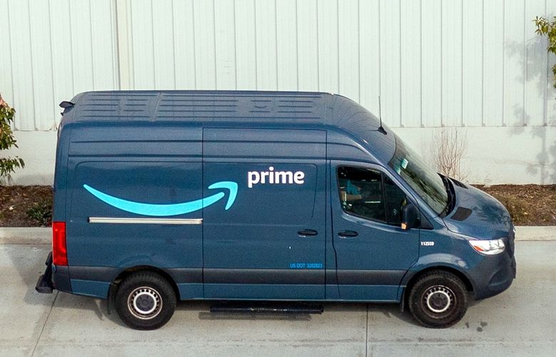 Amazon delivery vans at a shipping facility in Chatsworth, Calif., on Jan. 12, 2022. The company has big plans to turn its delivery fleet green, but very few of the vehicles are made right now. (Roger Kisby/The New York Times)