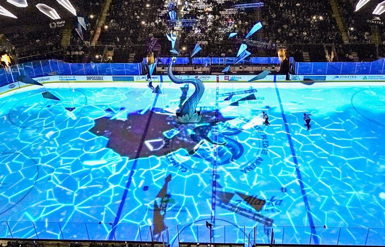 The ice appears to shatter before a massive tentacle during a light show before an NHL hockey game at Climate Pledge Arena between the Seattle Kraken and the San Jose Sharks, Thursday, Jan. 20, 2022, in Seattle. (AP Photo/Elaine Thompson) WAET111