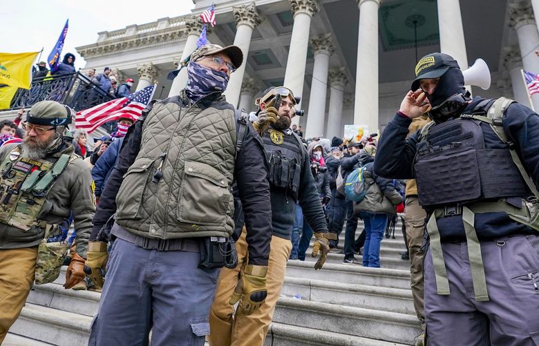 Members of the Oath Keepers on the East Front of the U.S. Capitol on Jan. 6, 2021, in Washington. The District of Columbia has filed a civil lawsuit seeking harsh financial penalties against far-right groups Proud Boys and Oath Keepers over their role in the Jan. 6 attack on the Capitol by supporters of former President Donald Trump. (AP Photo/Manuel Balce Ceneta) DCMC501