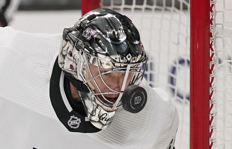Los Angeles Kings goaltender Jonathan Quick deflects a shot off of his mask during the first period of an NHL hockey game against the Colorado Avalanche Thursday, Jan. 20, 2022, in Los Angeles. (AP Photo/Mark J. Terrill) LAS102 LAS102